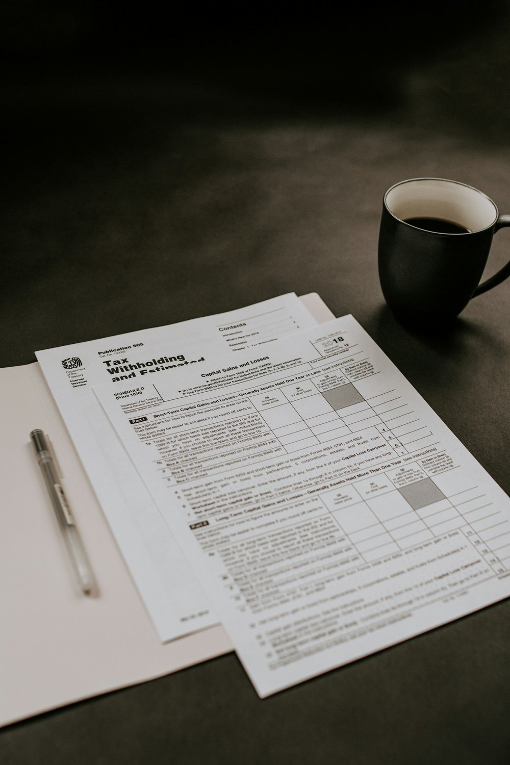 Tax planning paperwork and calculator on a desk